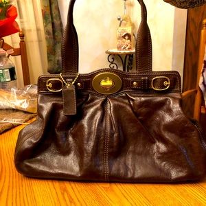 Coach 
women’s brown leather purse.
Light purple interior lining.
